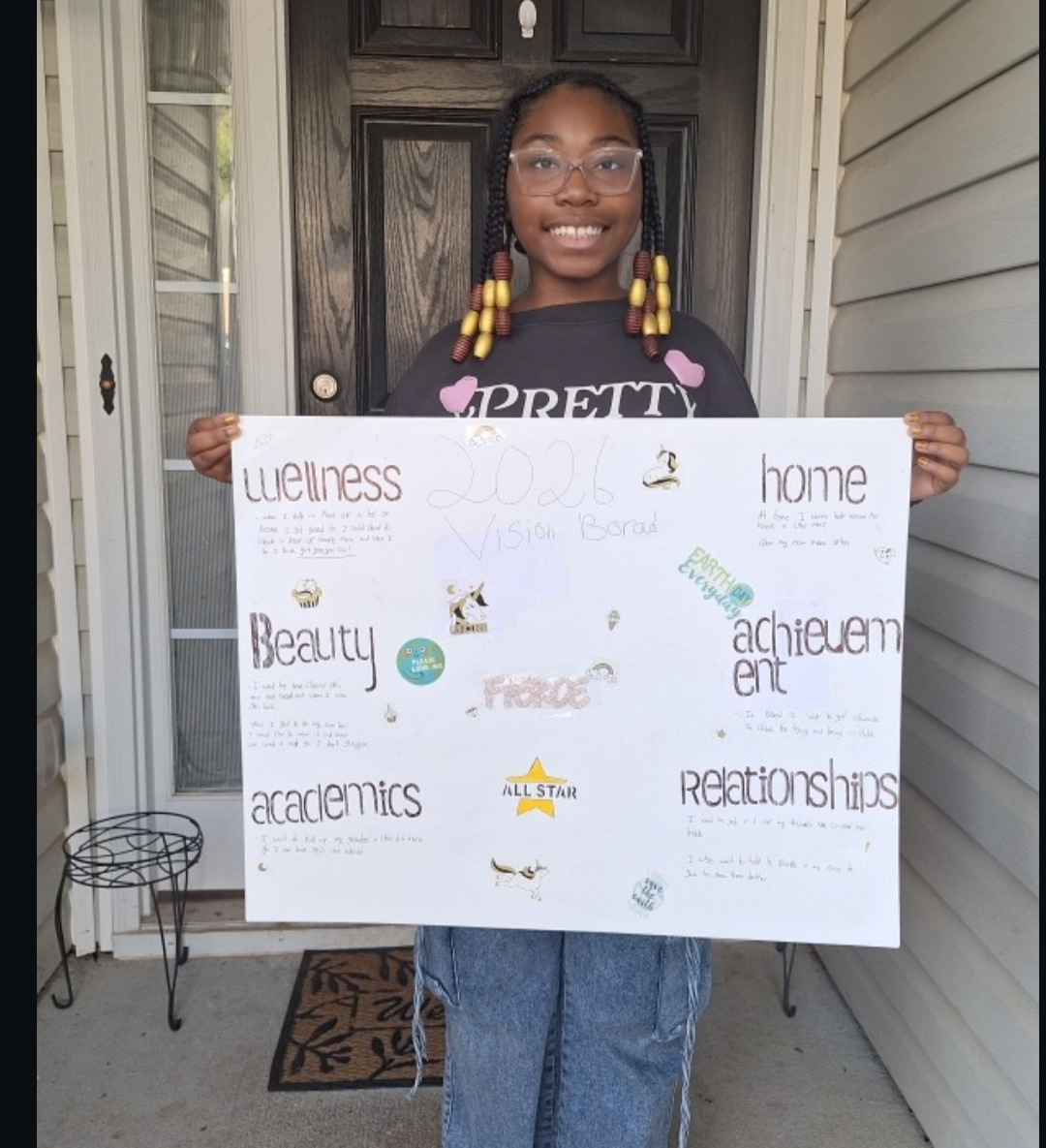 Girl holding her vision board on the virtual vision board party